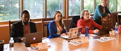 Students working a gubernatorial debate on campus